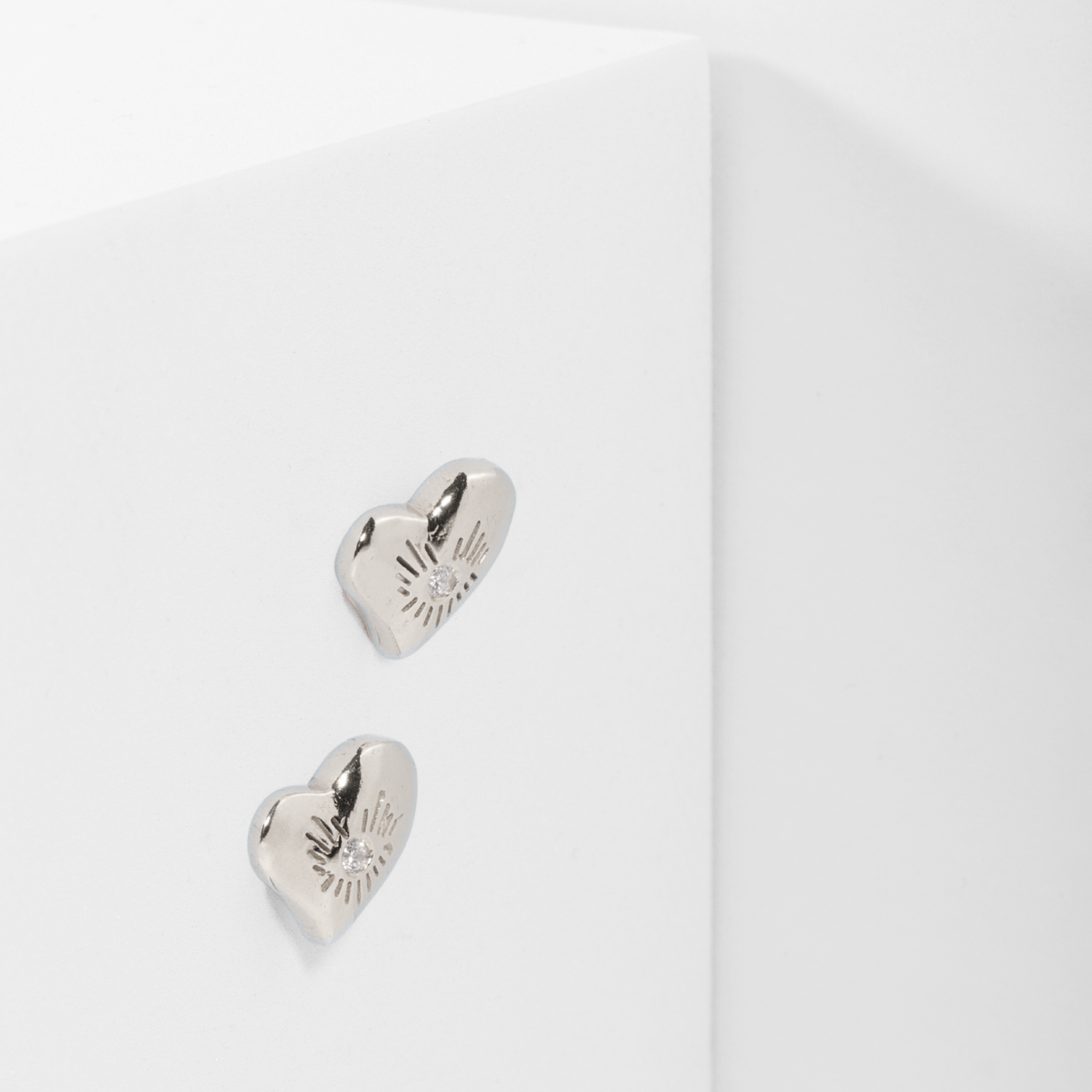 bright heart earrings in sterling silver, with ethical diamonds, side view. Carlota Guardia Jewelry
