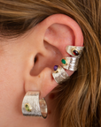 Reptilia silver earcuff with natural gemstone, worn on ear.