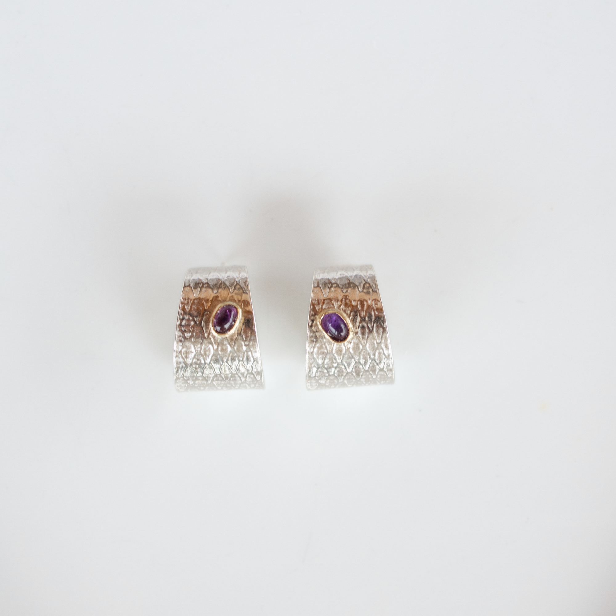 Reptilia silver textured earrings with amethyst front view.