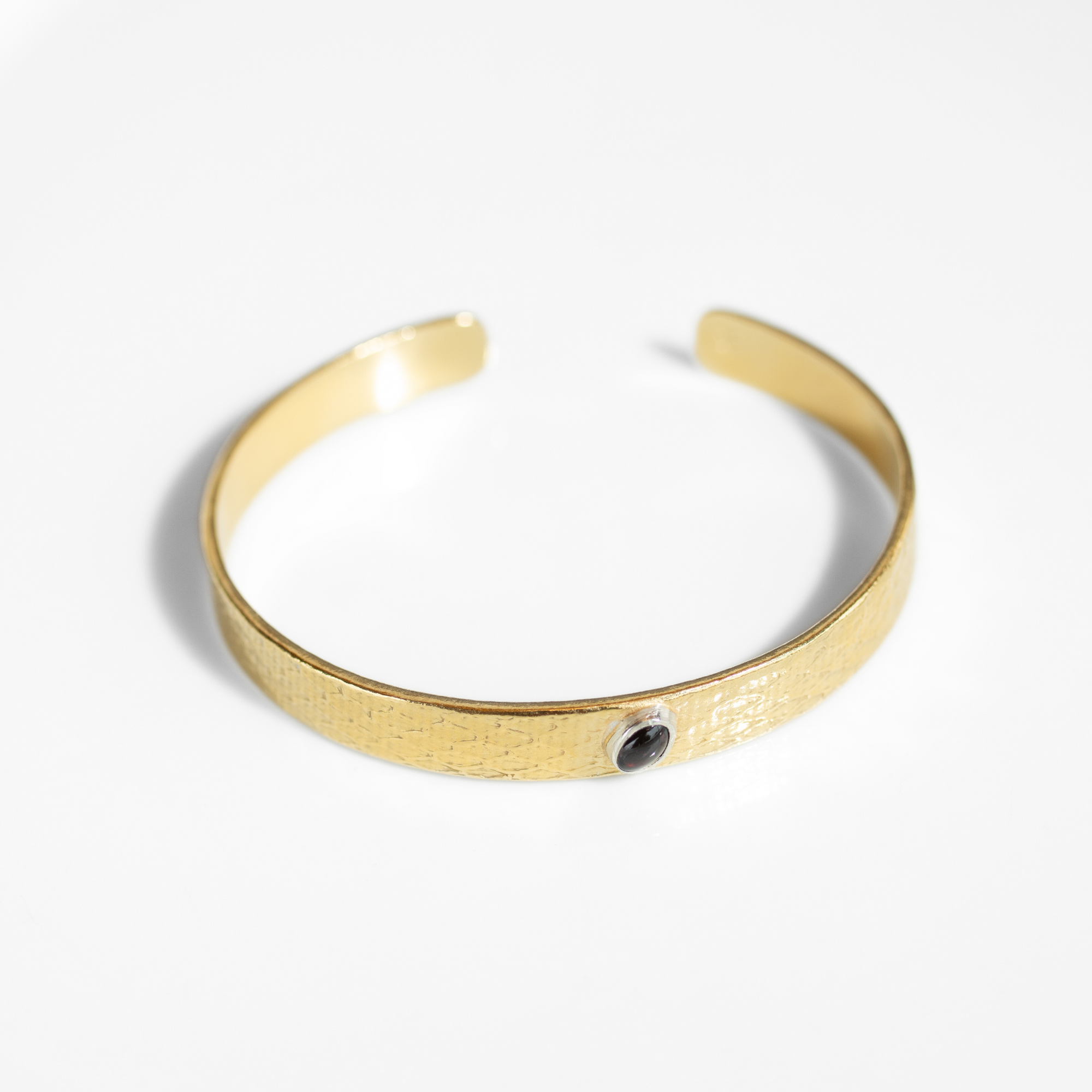 Reptilia Minima vermeil cuff with natural gemstone cabochon, front view on white.