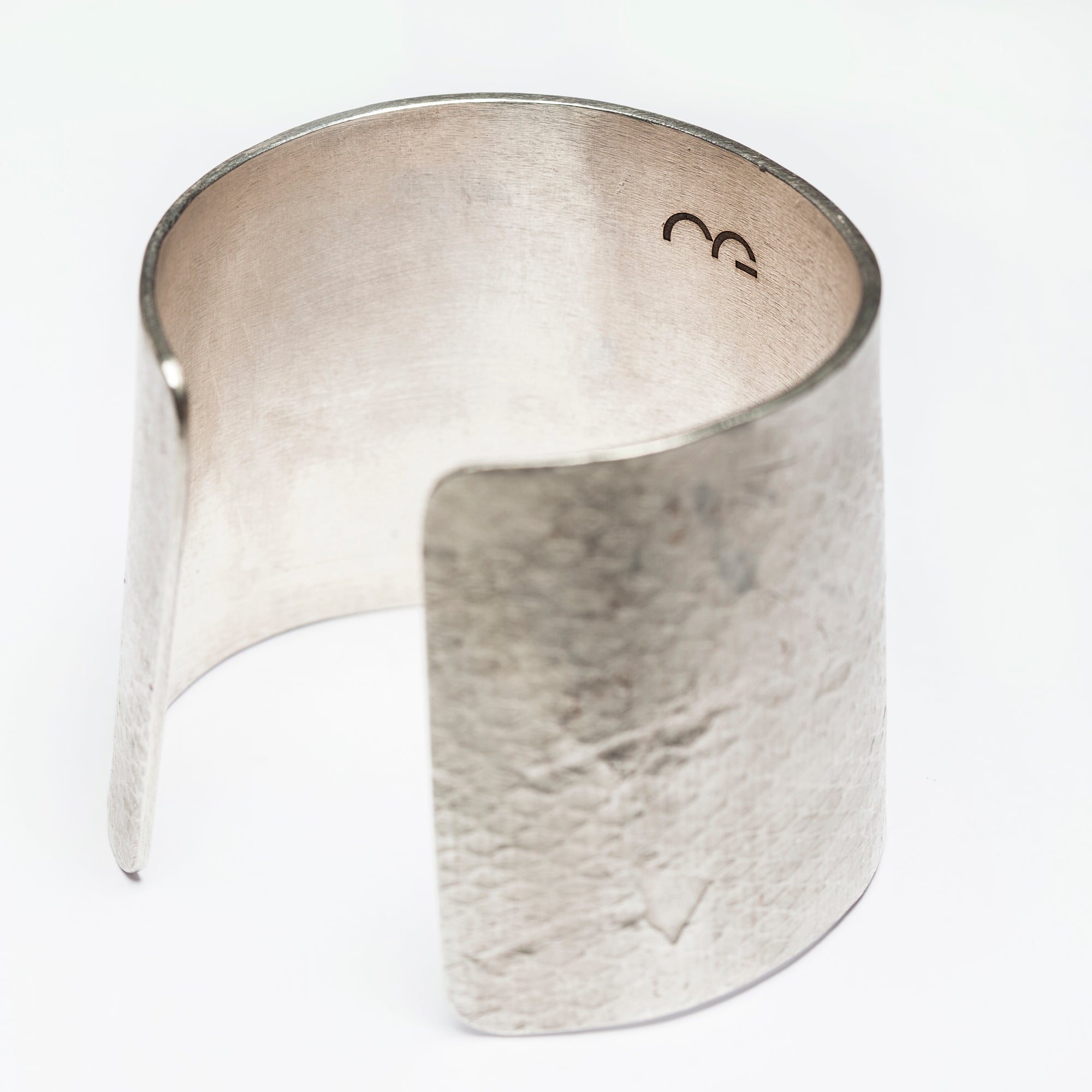 Interior and back view of the Reptilia Maxima silver cuff showing the open design and texture.